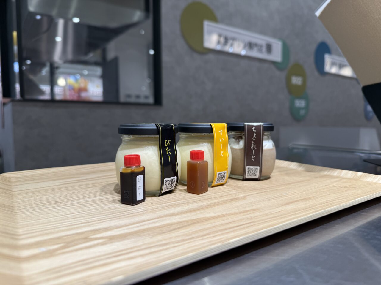 木製トレイに並ぶ3種類のプリンと別添えソース