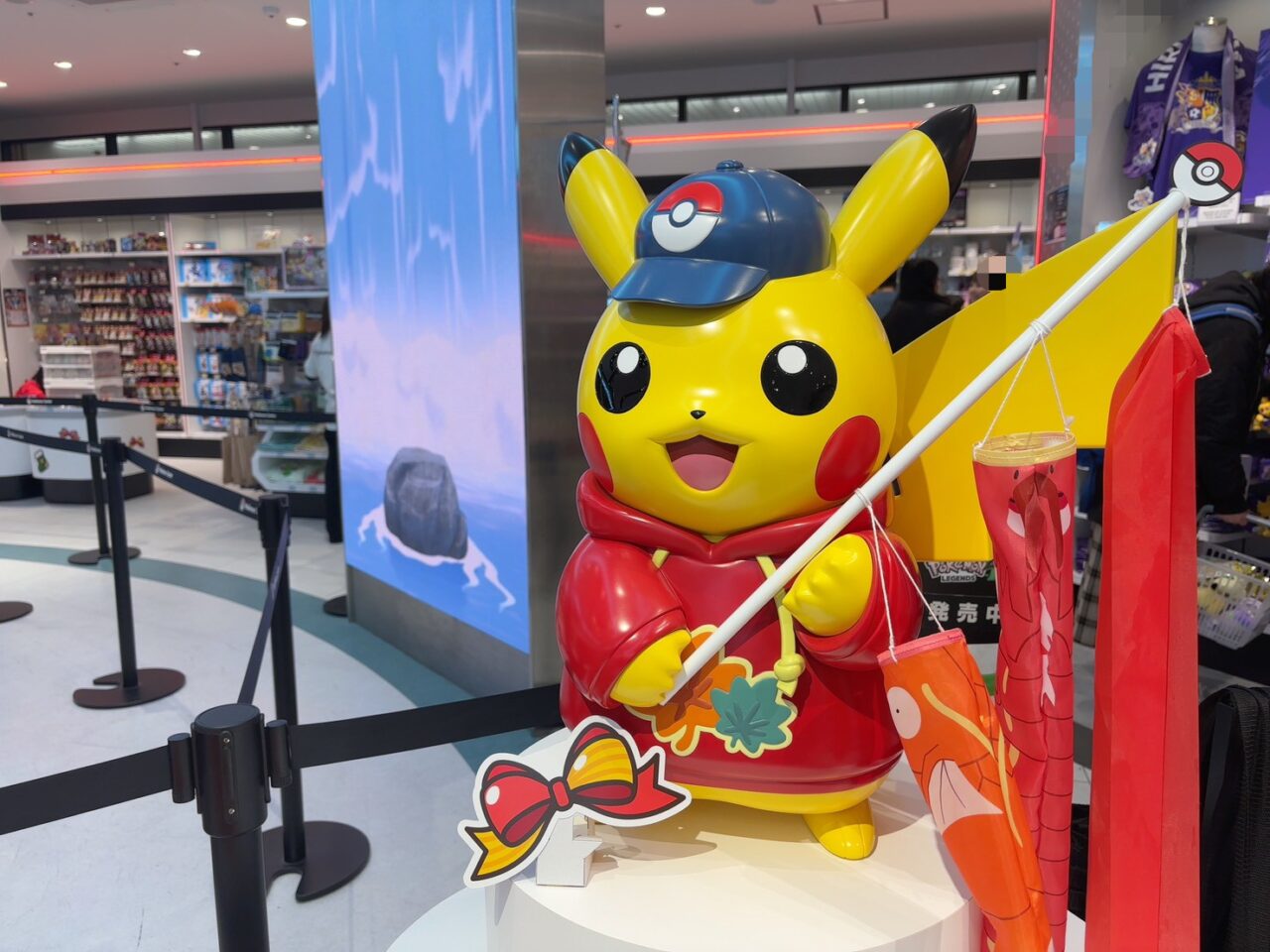 ピカチュウのぬいぐるみやキーホルダーが並ぶ販売コーナー